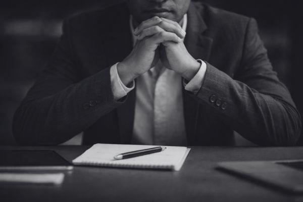 business consultant thinking before making strategic decision at desk